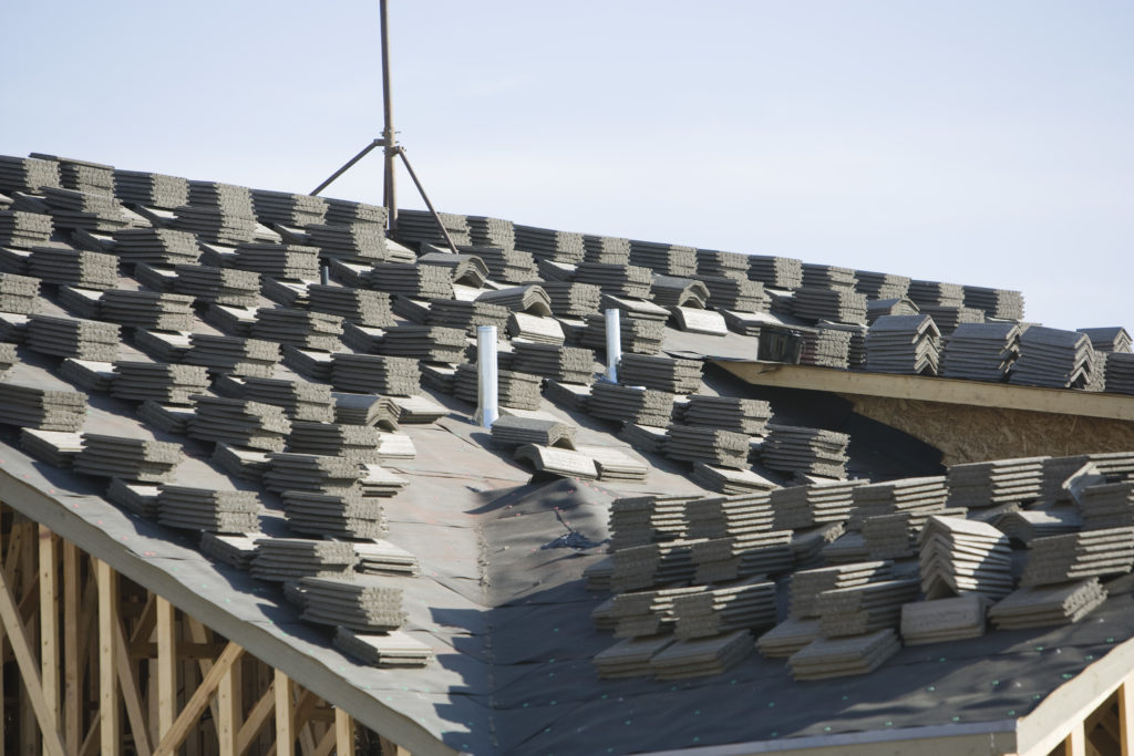 Stacks of tiles on house roof